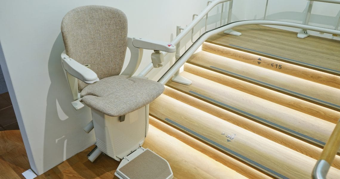 Stairlift installed next to a staircase in a home.